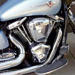 Kawasaki pulled out all the stops to make the biggest production V-twin going. With a 103mm bore and 123.2mm stroke, the Vulcan's engine the largest production V-twin and the most undersquare of this bunch, with a bore/stroke ratio of 0.83:1. (Honda's is 0.89:1; the Yamaha is 0.85:1. A typical sportbike's ratio is around 1.5:1.) Generally, a long-stroke engine builds torque strong and fast, as the Vulcan does with a vengeance, peaking at 121.4 foot-pounds, 16.8 foot-pound above the Honda. Its four valves per cylinder—chosen most likely as much to provide additional heat paths through the valves as for their breathing ability—are operated by four pushrods and two cams located in the right engine chest, as Harleys have done forever. Pushrods? On a brand-new design? It makes sense, actually, if you intend to keep the engine as short as possible, a task made tougher by the long stroke. Besides, the rev limit on this engine (actually 5000 rpm) is set by maximum piston speed, which in turn dictates a redline well within the capabilities of a modern pushrod valve train. Hydraulic lash adjusters make the valve train maintenance-free. and Kawasaki's usual excellent gear-driven counterbalancer helps flatten the considerable vibes inherent in this design.